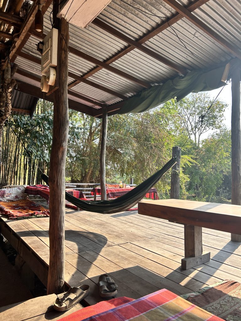 Chilled riverside spot on Don Det with hammocks and floor seating – perfect for slow island days